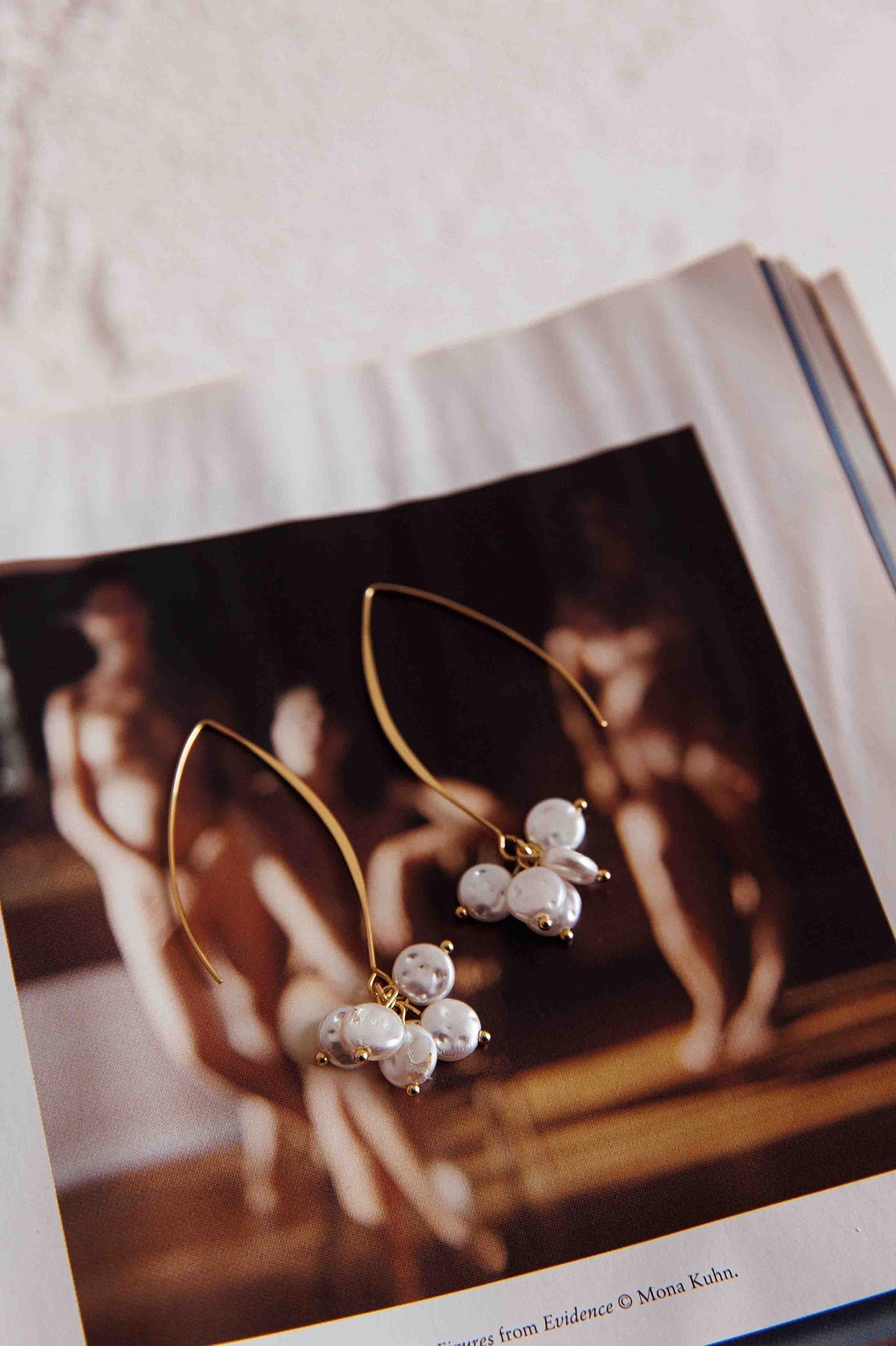 Long hook earrings with gold pearl accents